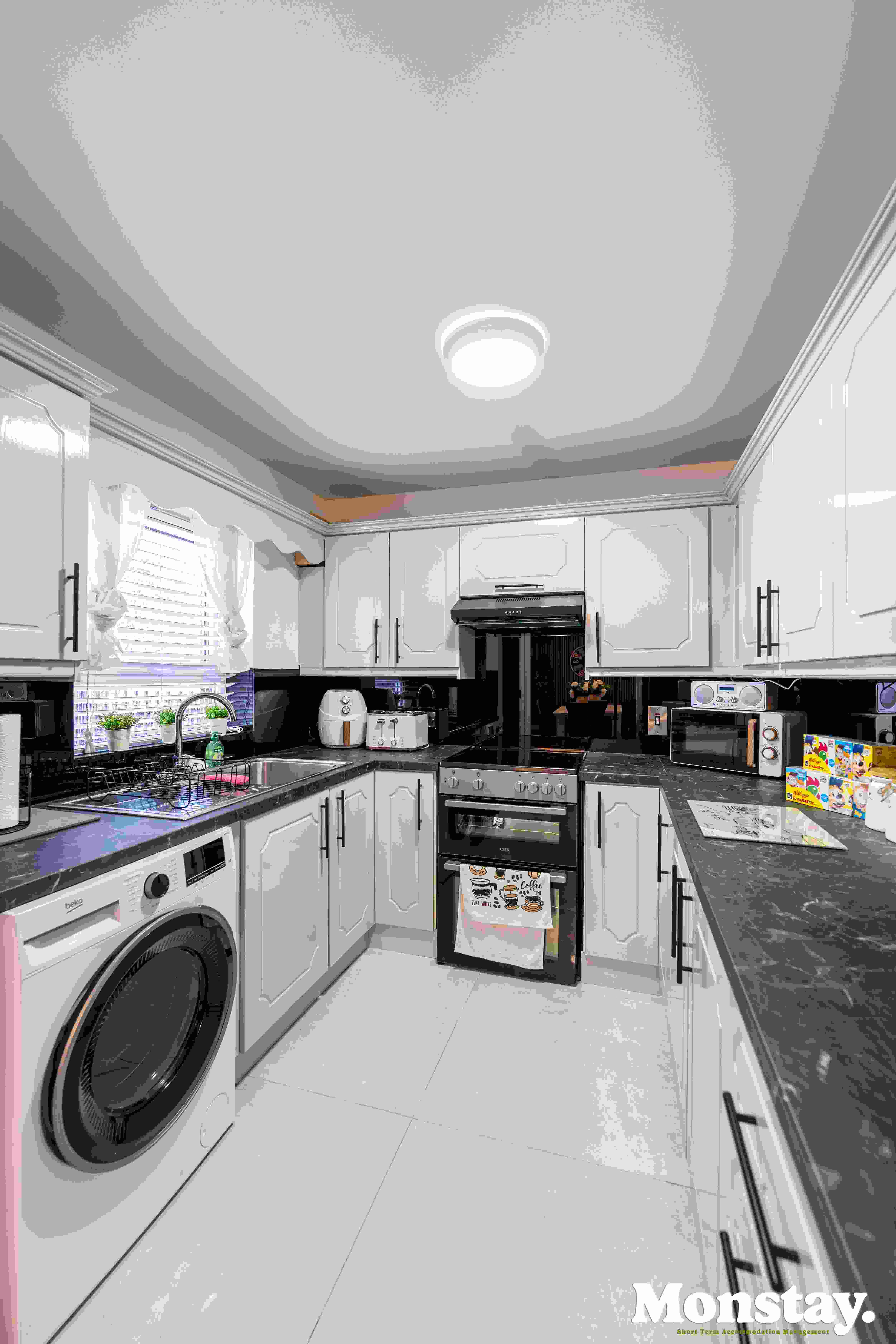 Fully fitted modern kitchen with cooker and air fryer at Walled City House Derry